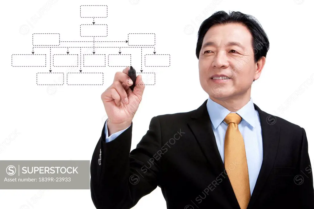 Senior businessman drawing a diagram