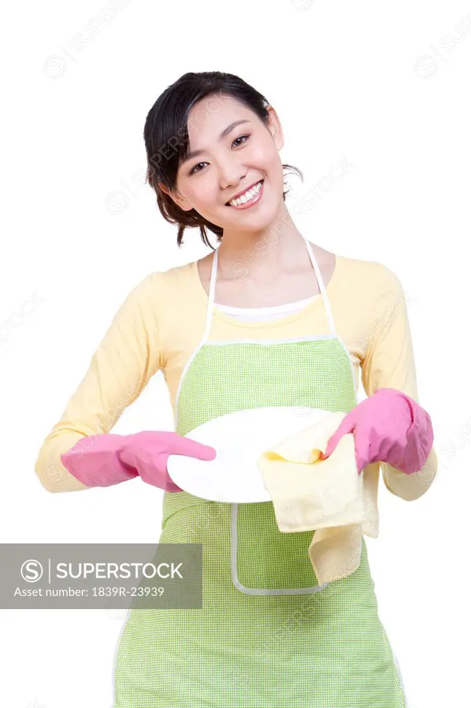 Happy housewife drying the plate