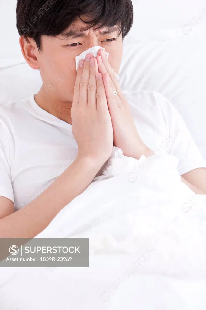 Young man sick in bed