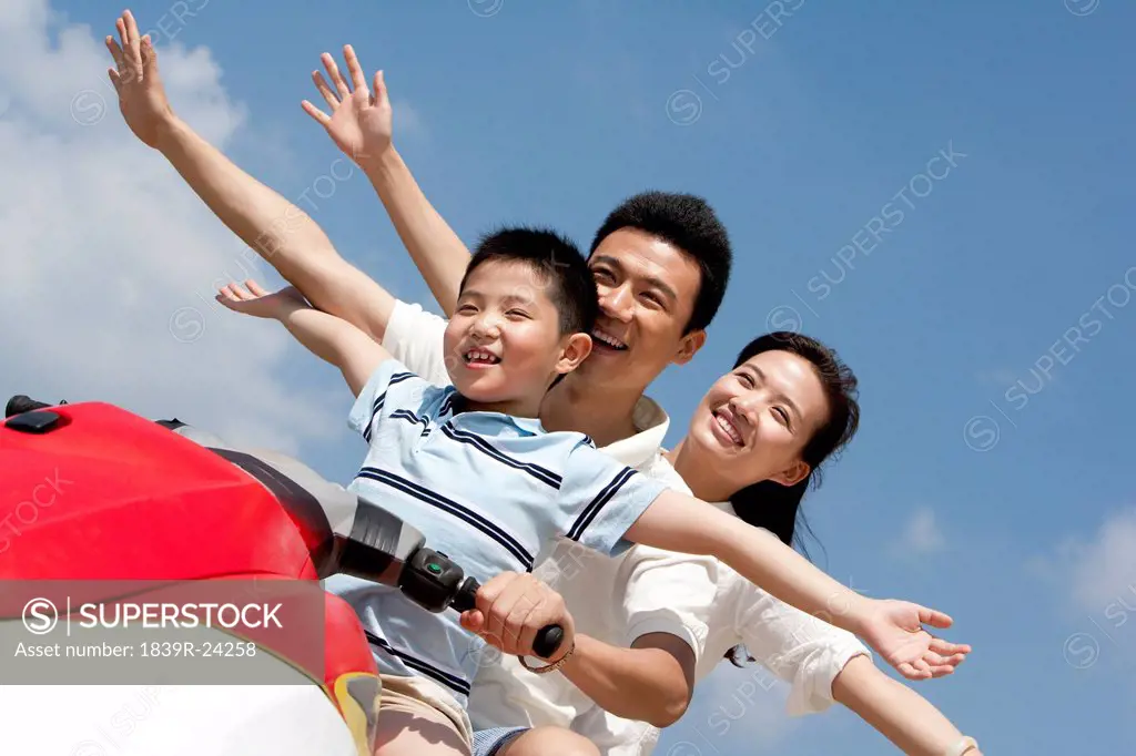Happy Family Riding on a Jet Ski