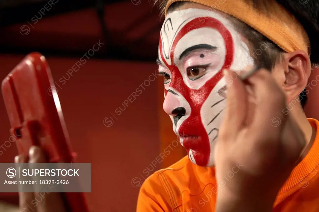 Man Applying Traditional Face Paint