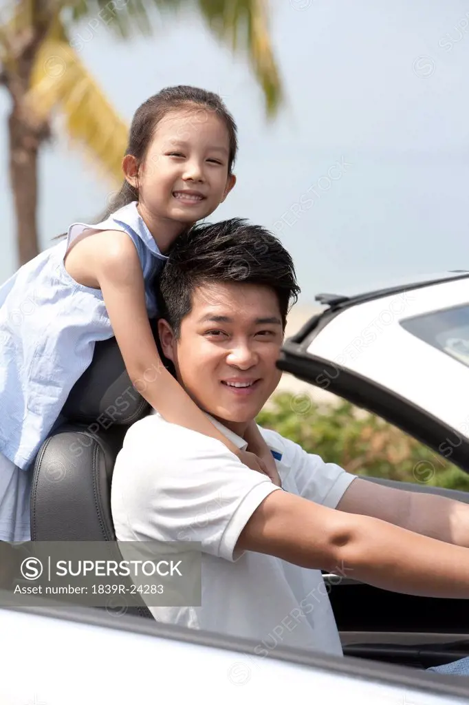 Father and Daughter Driving in a Convertible