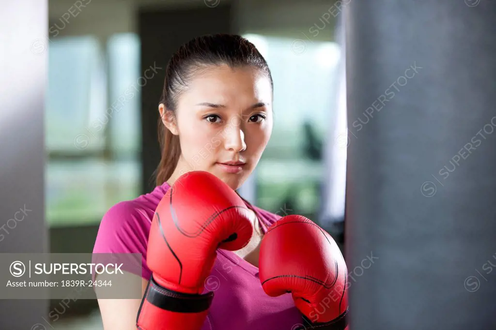 Confident Young Woman in Boxing Gloves