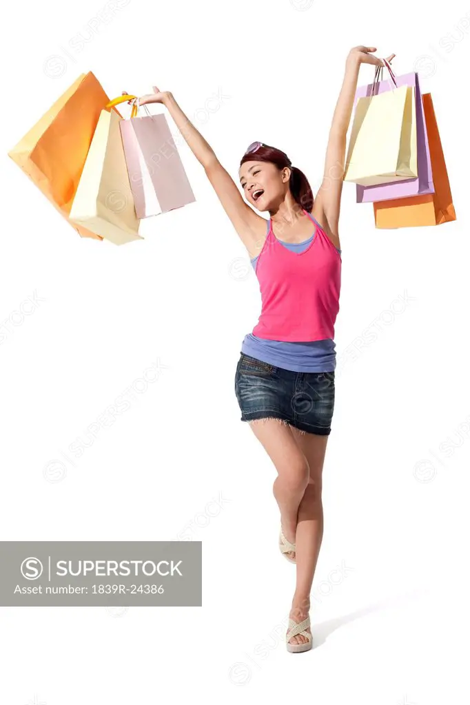 Happy young woman holding shopping bags