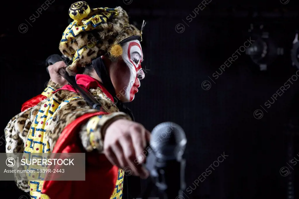 Man In Ceremonial Costume With Microphone
