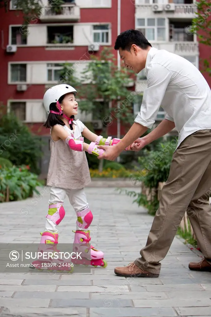 Chinese father and daughter in rollerblades
