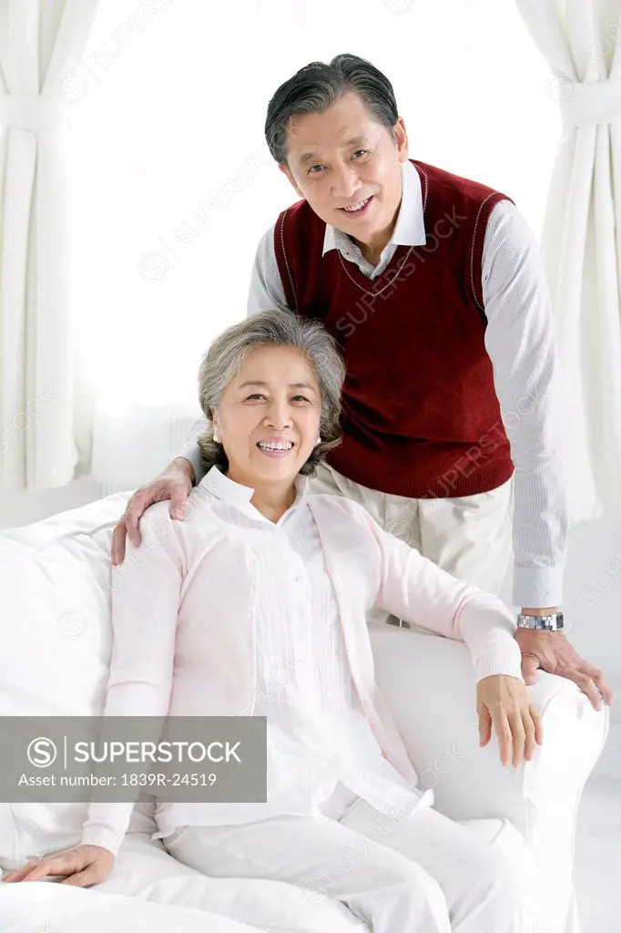 Senior Chinese couple in living room