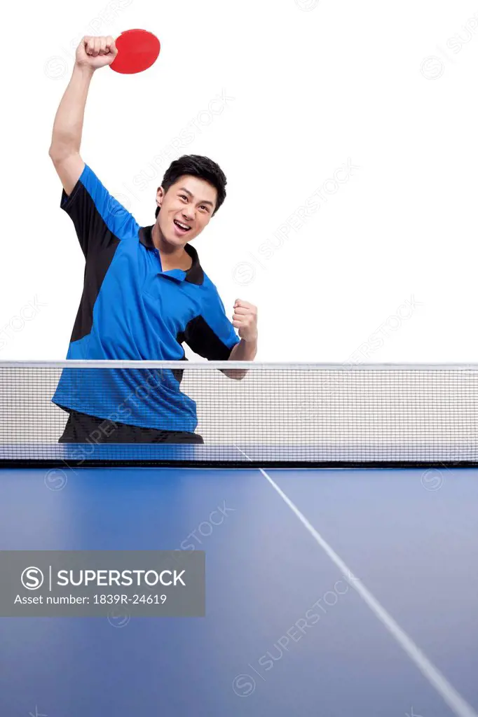 Table tennis player practices swings with determination