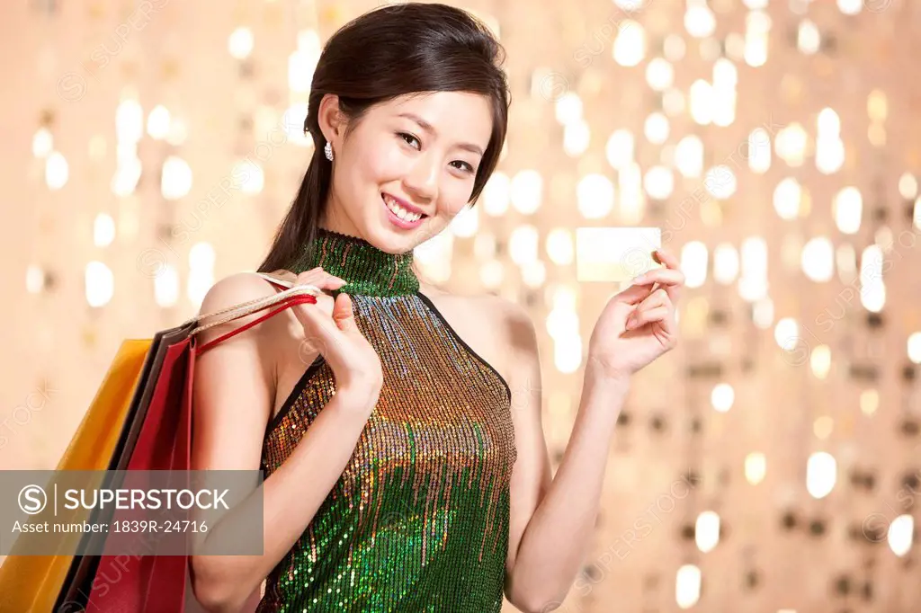 Stylish young woman going shopping with crdit card