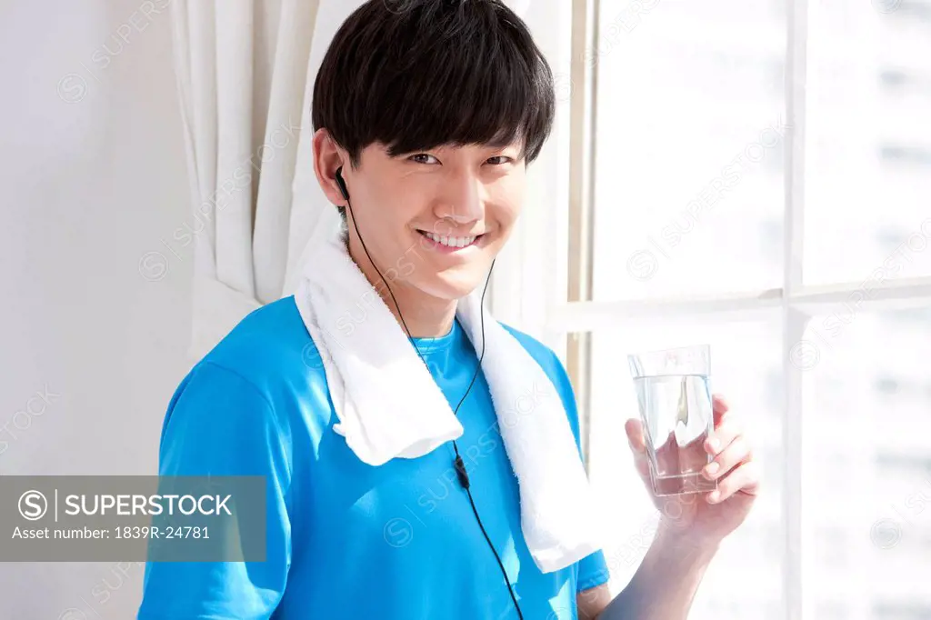 Young man drinking water after doing work_out