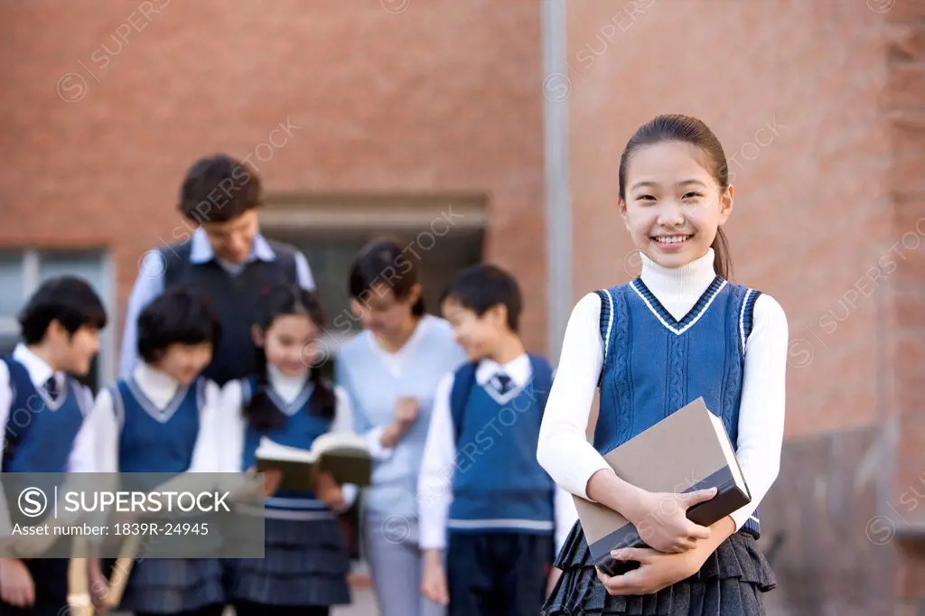 Young student standing confidently in the foreground