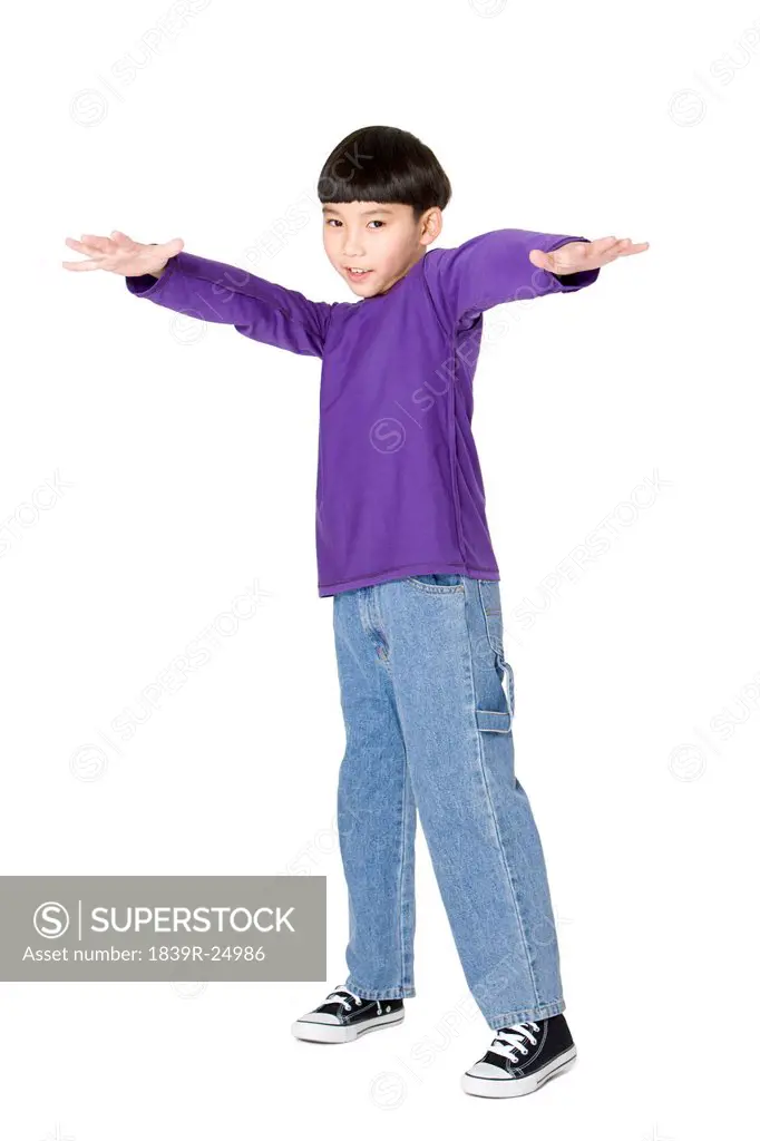 Young smiling boy holding arm up