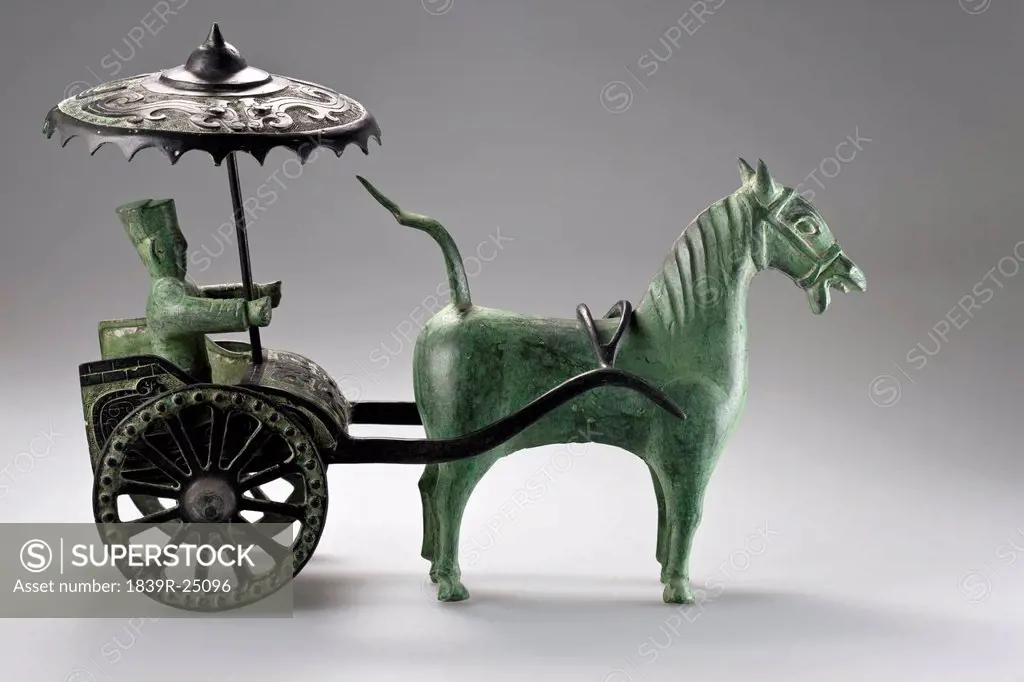 Chinese sculpture of a man riding a chariot