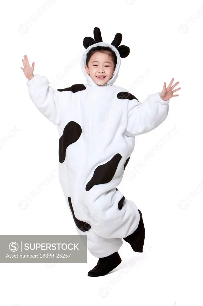 Cute girl in a cow costume playing