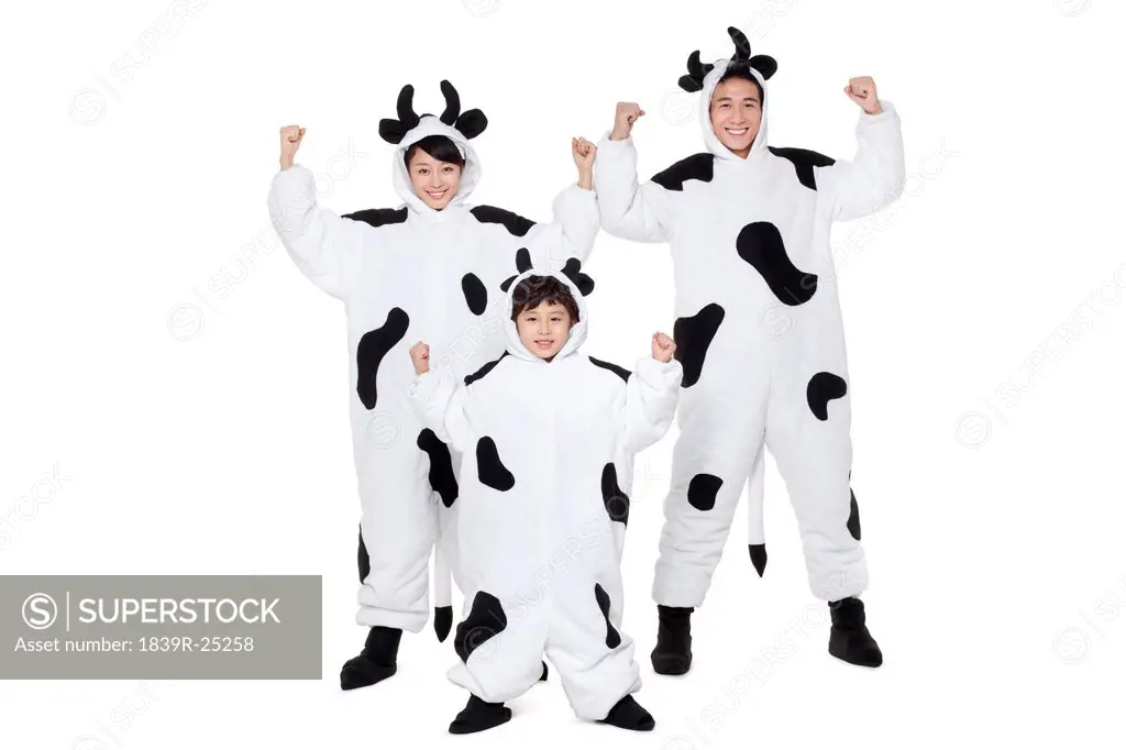 Family in cow costumes flexing their muscles