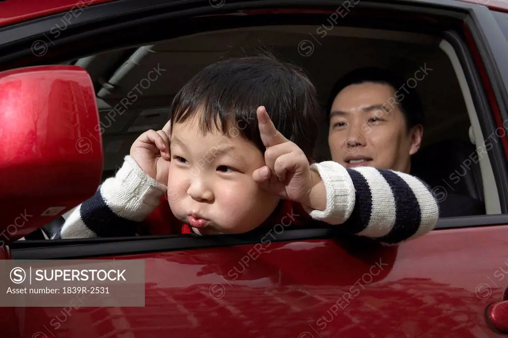 Young Child Pulling Face In Car