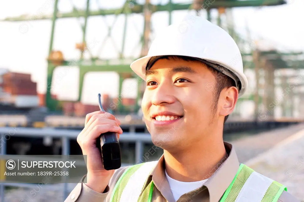 shipping industry worker using a walkie_talkie