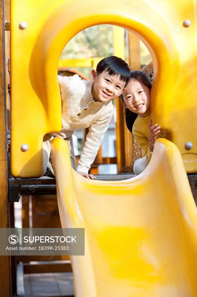 Children playing on playground slide