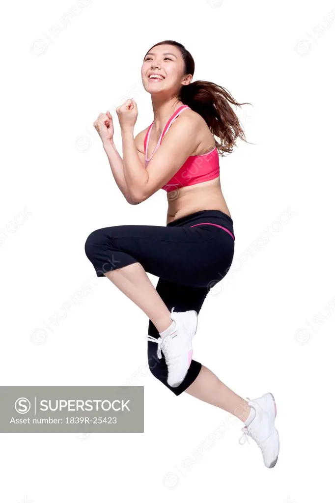 Excited young woman doing aerobics