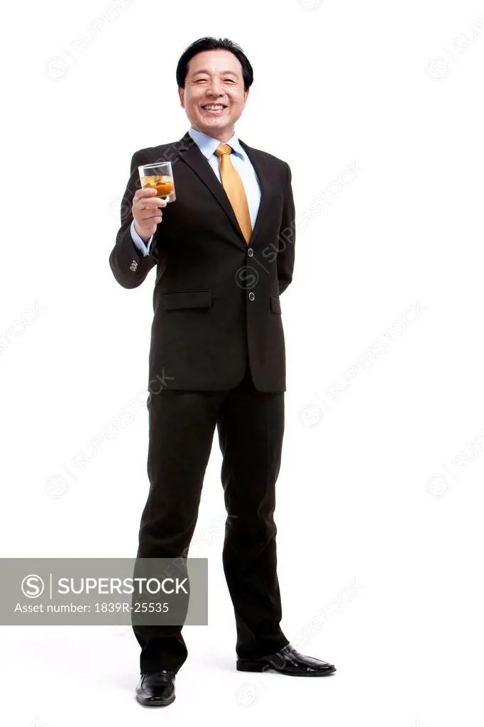 Senior businessman holding a glass of whiskey