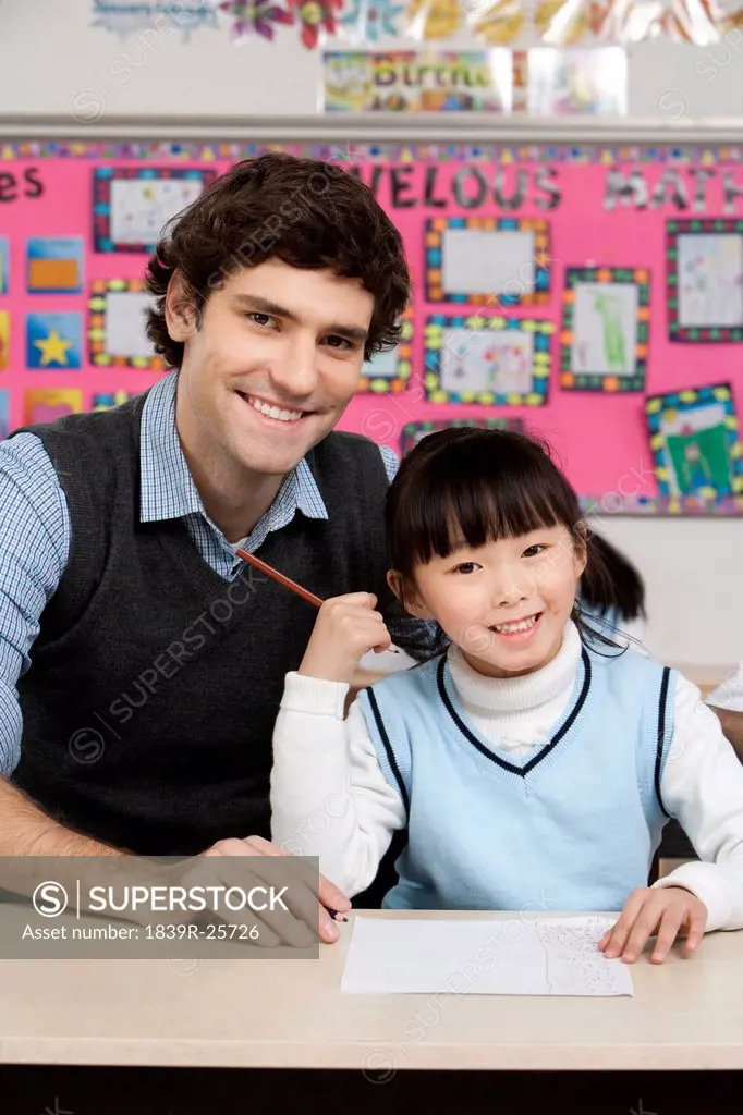 Teacher and student smiling into the camera during class