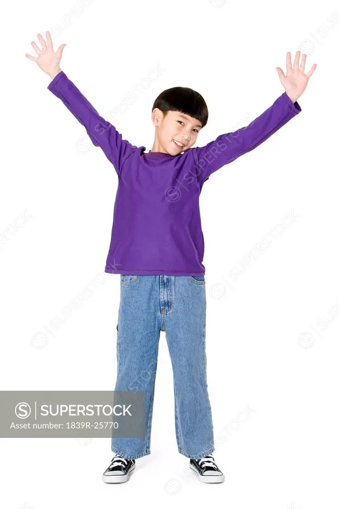 Young boy smiling with arms outstretched
