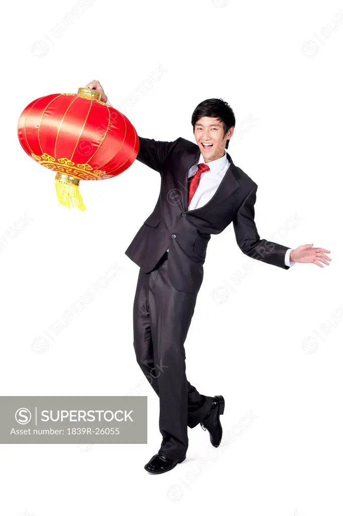 Excited Businessman Holding a Chinese Lantern
