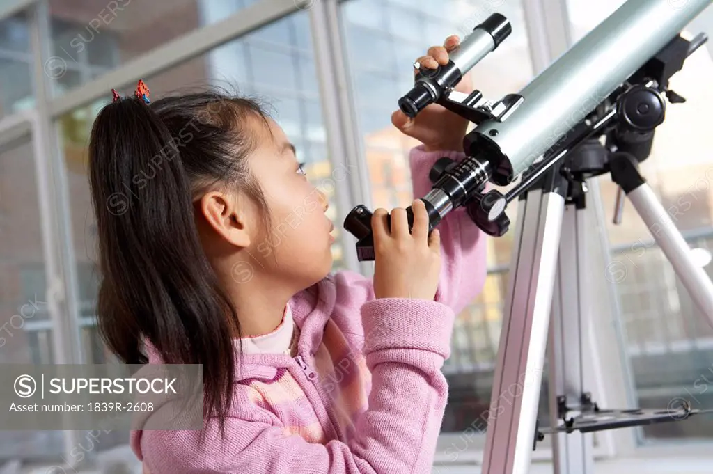 Girl Looking Through Telescope