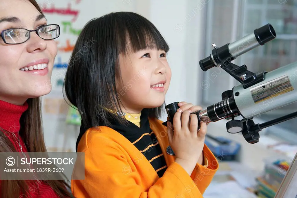 Girl And Teacher Holding Telescope, Looking Into Distance
