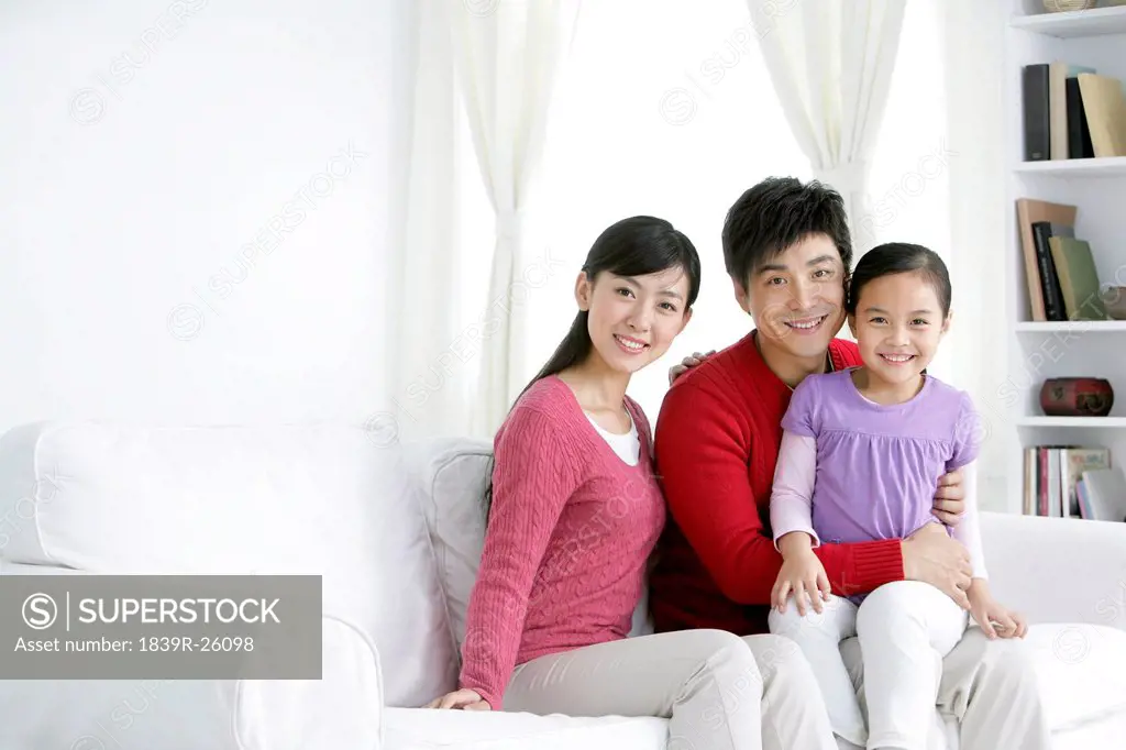 Young Chinese family in living room