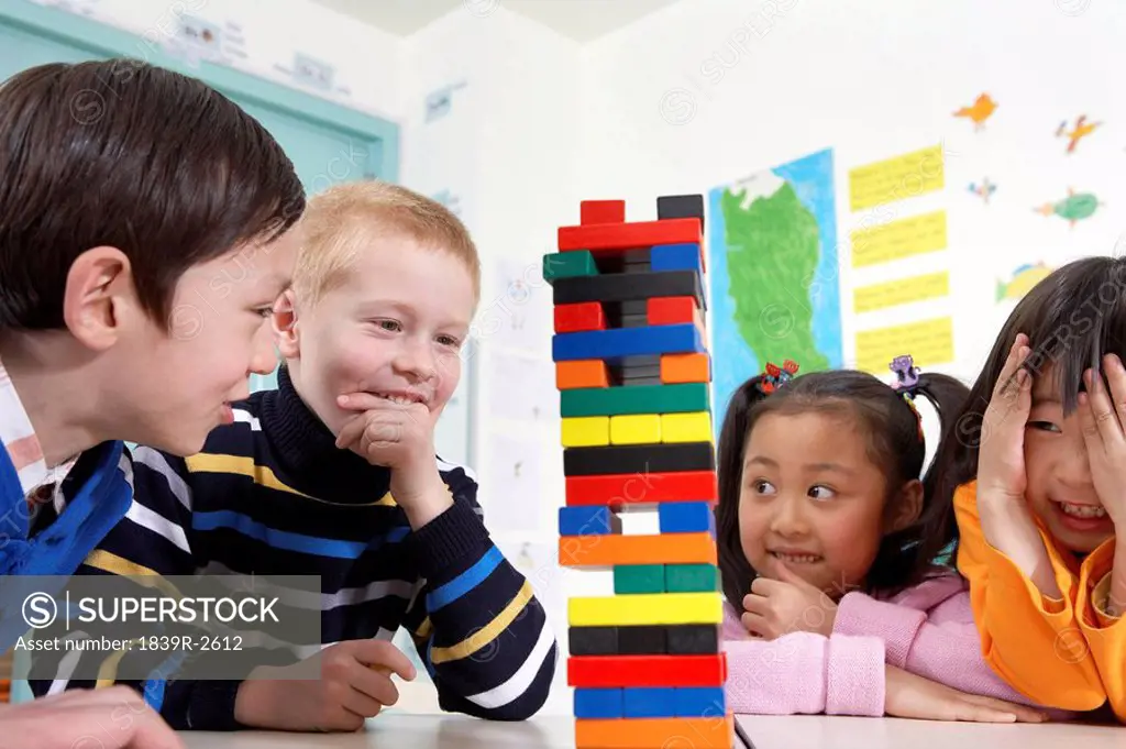 Children Looking At Tower Of Blocks