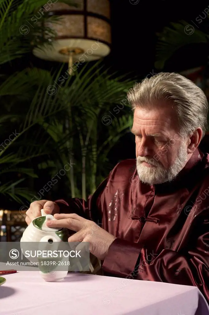 Man Pouring A Cup Of Tea