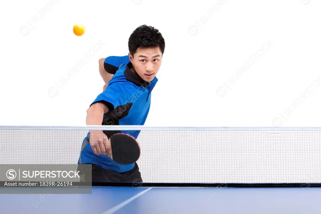 Table tennis player hitting ball