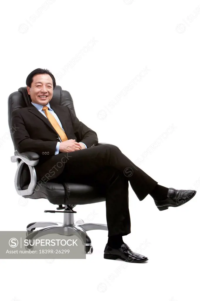 Senior businessman sitting on director´s chair
