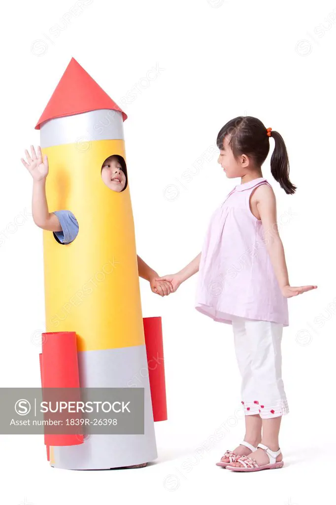 Boy and girl with a toy rocket