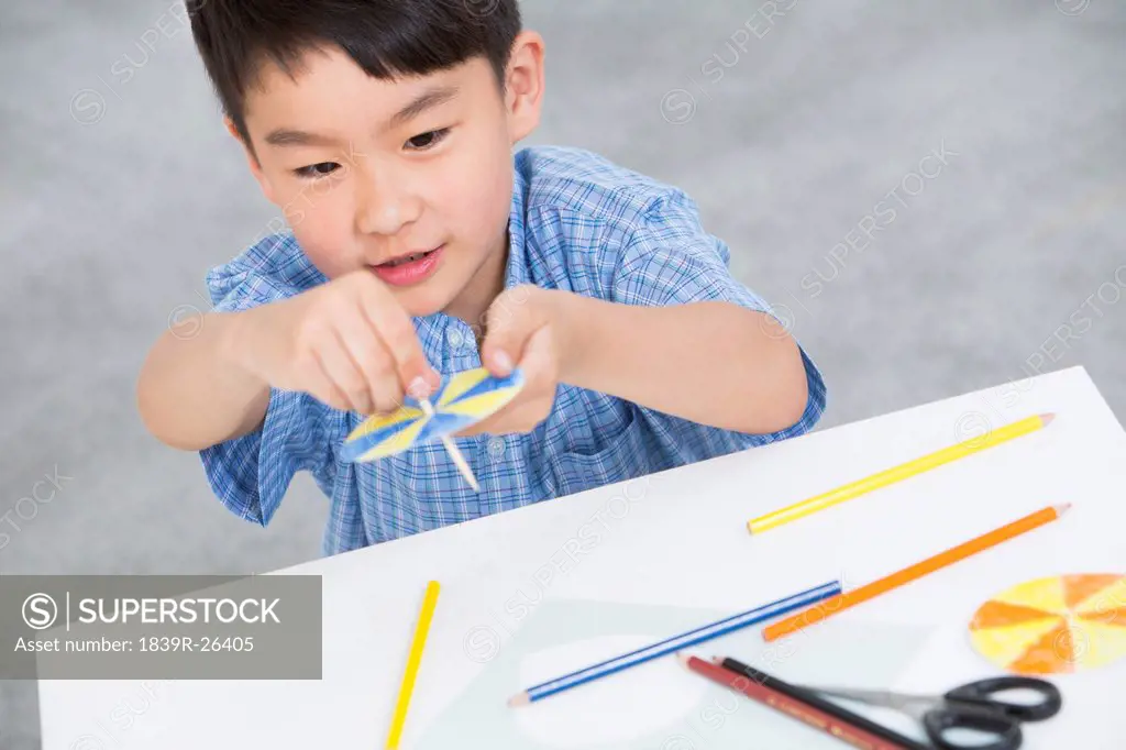 Boy making a paper toy