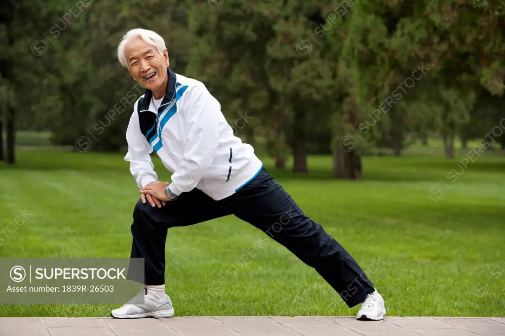 Senior Man Stretching in a Park