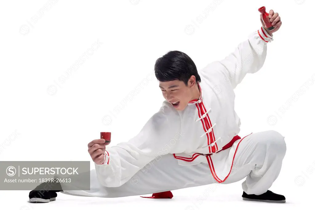 Excited Man In Traditional Chinese Clothing Holding up Cup
