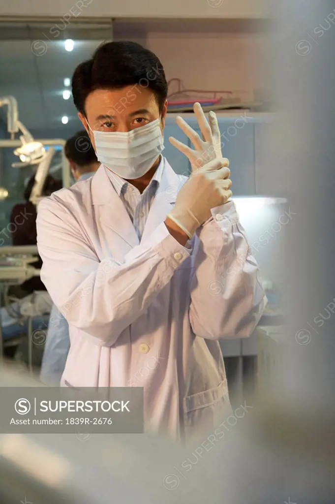 Dentist Putting On Rubber Gloves