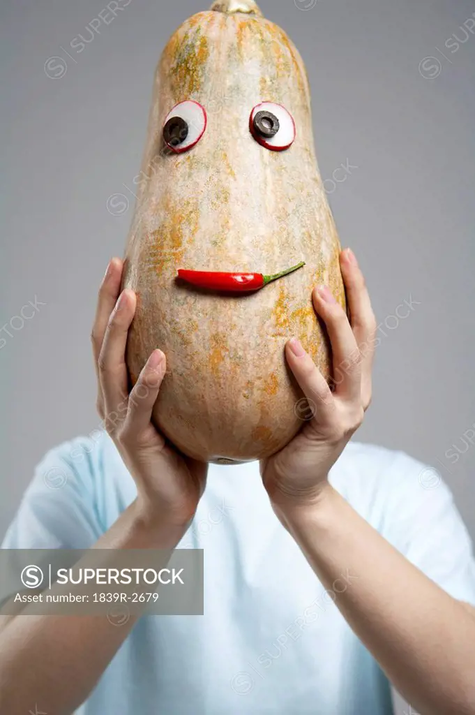 Male Covering Face With Vegetable Mask