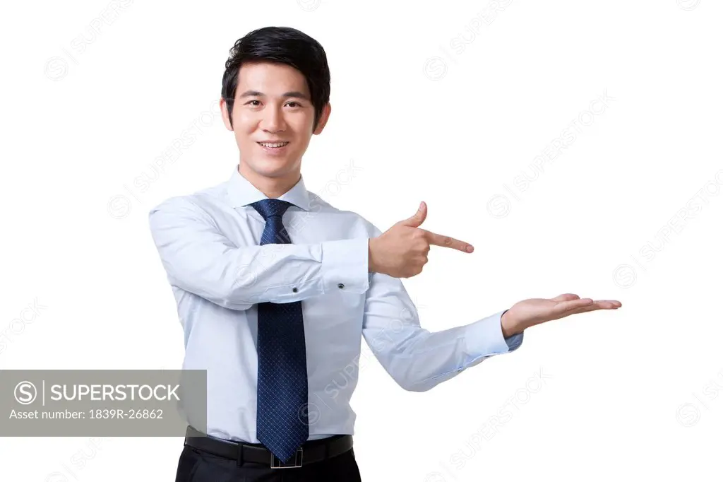 Portrait of a Businessman Pointing at an Empty Object