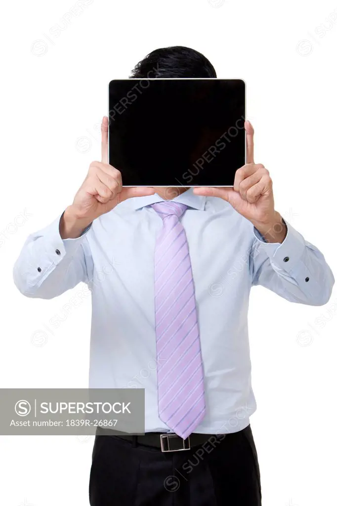 Businessman Holding a Digital Tablet Over His Face