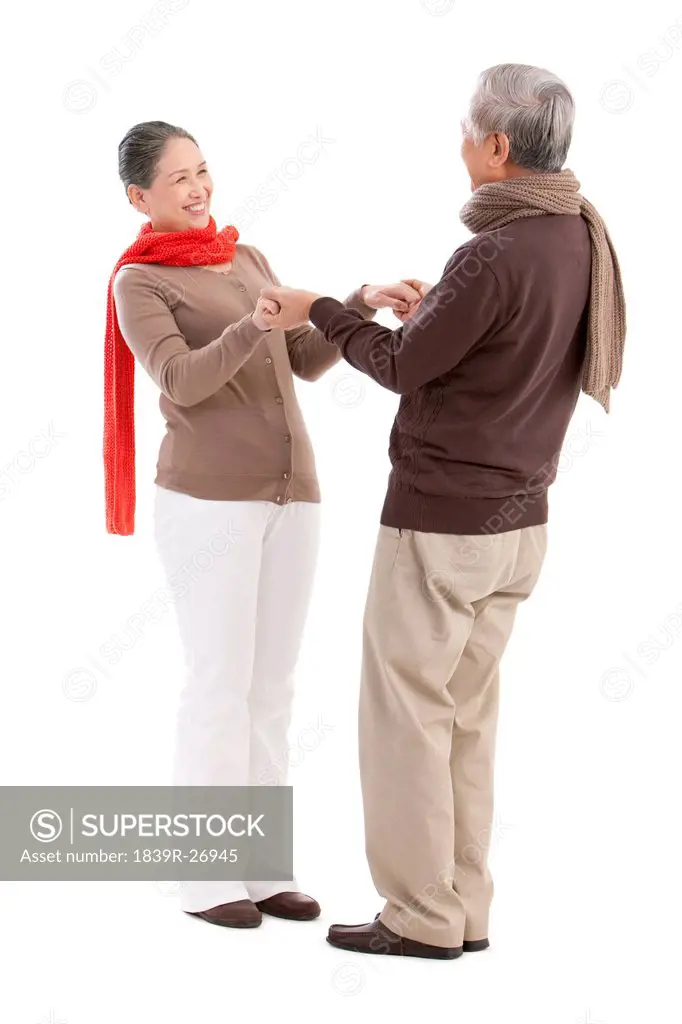 Senior affectionate couple holding hands