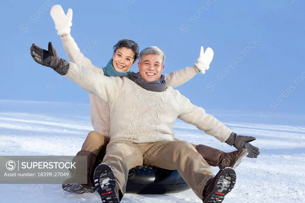 Senior couple having fun in snow