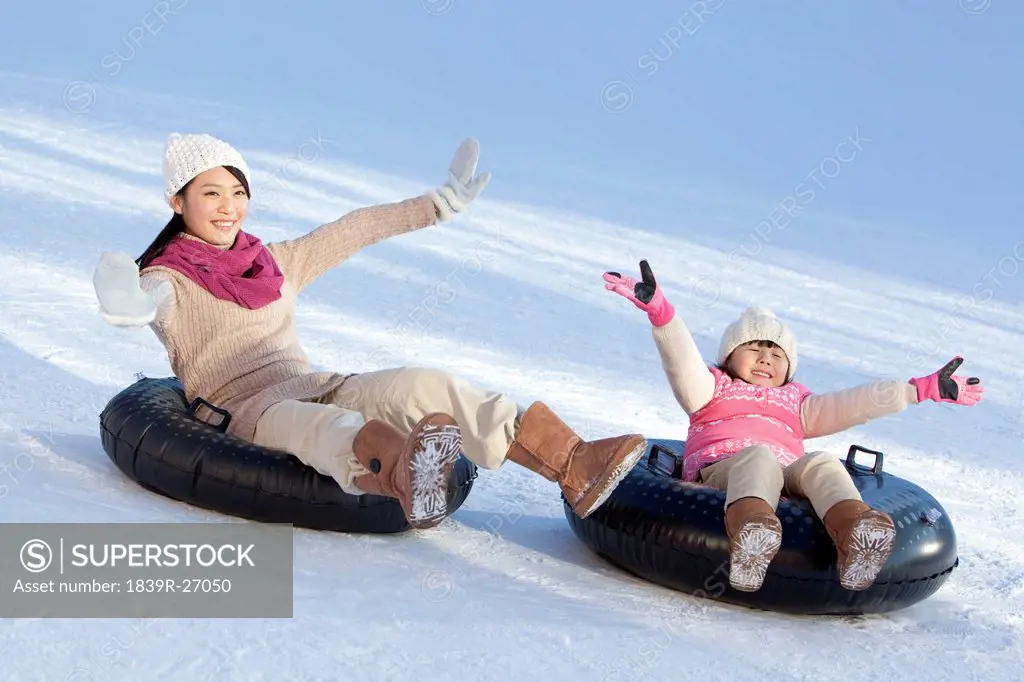 Mother and daughter having fun in snow