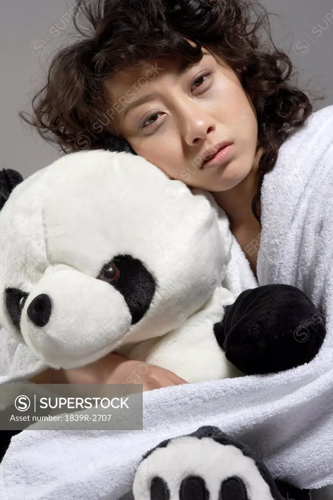 Young Woman In Bed Holding Panda Soft Toy