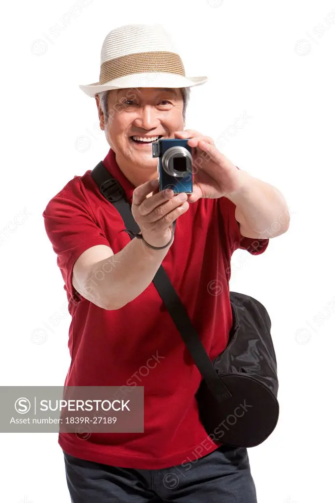 Portrait of senior man holding a camera