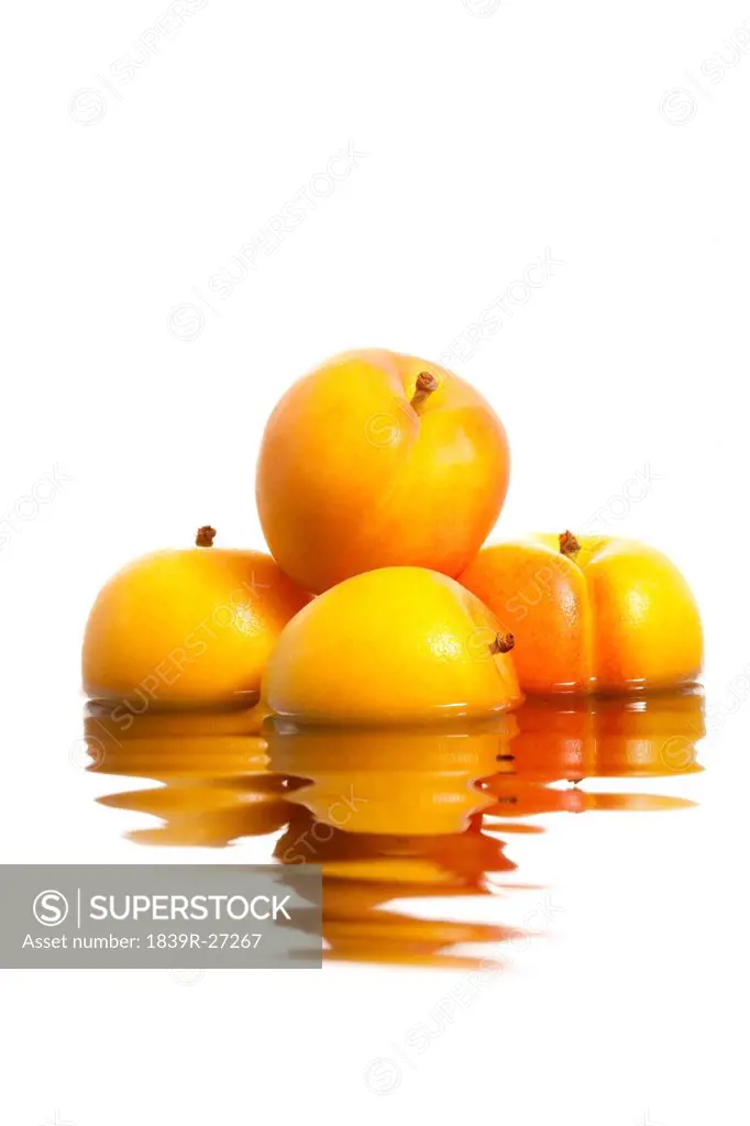 Apricots with reflection on rippling water surface