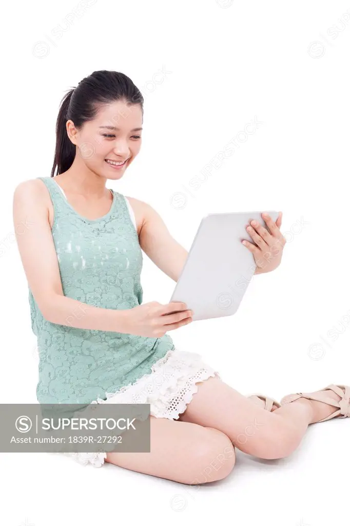 Happy young woman and digital tablet