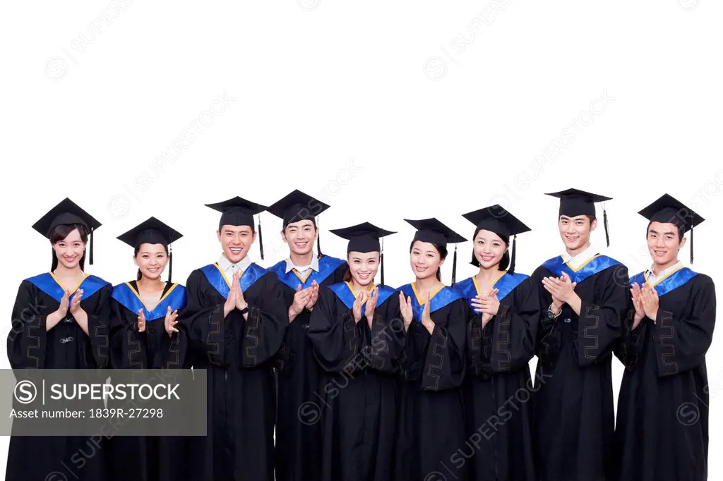Portrait of graduates clapping hands